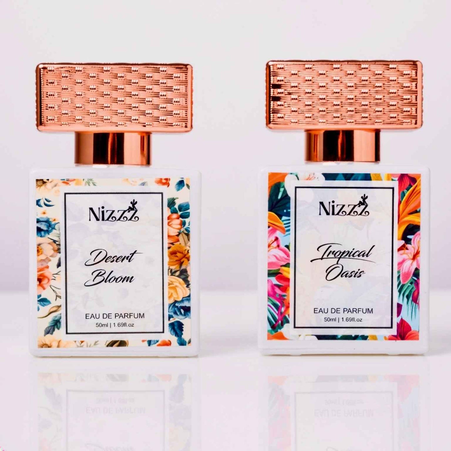 Two Nizzz floral perfume bottles: Desert Bloom & Tropical Oasis, 50ml eau de parfum with rose gold caps