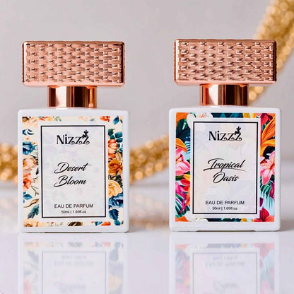 Two floral perfume bottles: Desert Bloom & Tropical Oasis Eau de Parfum with rose gold caps, 50ml each