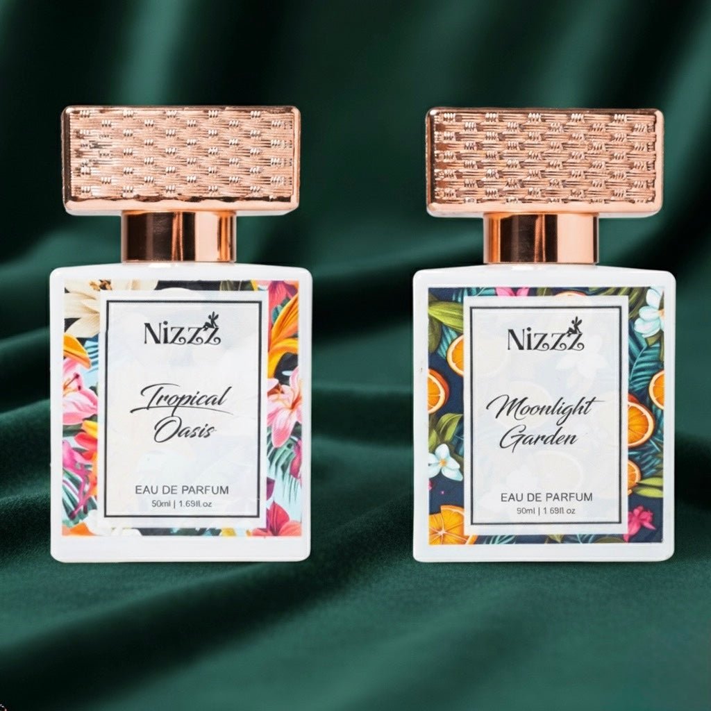 Two Nizzz floral perfumes: Tropical Oasis and Moonlight Garden eau de parfum with rose gold caps on green velvet