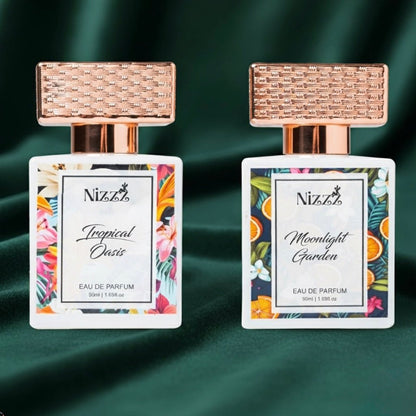Two Nizzz floral perfumes: Tropical Oasis and Moonlight Garden eau de parfum with rose gold caps on green velvet