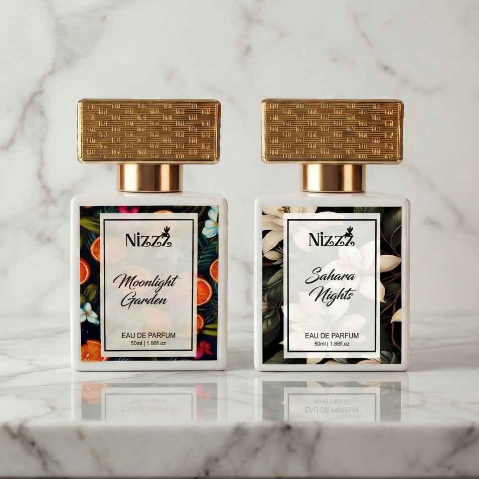 Two elegant Nizzz floral perfumes, Moonlight Garden and Sahara Nights, on marble surface