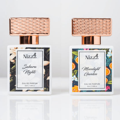 Two elegant floral perfume bottles with rose gold caps, Sahara Nights and Moonlight Garden eau de parfum