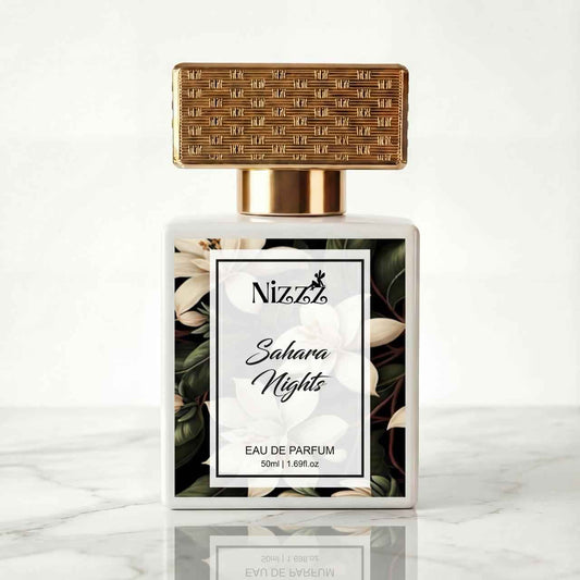 Nizzz Sahara Nights Eau de Parfum bottle with floral design and gold cap on marble surface