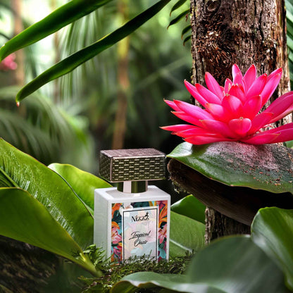 Tropical Oasis perfume bottle nestled among lush green leaves and a vibrant pink flower