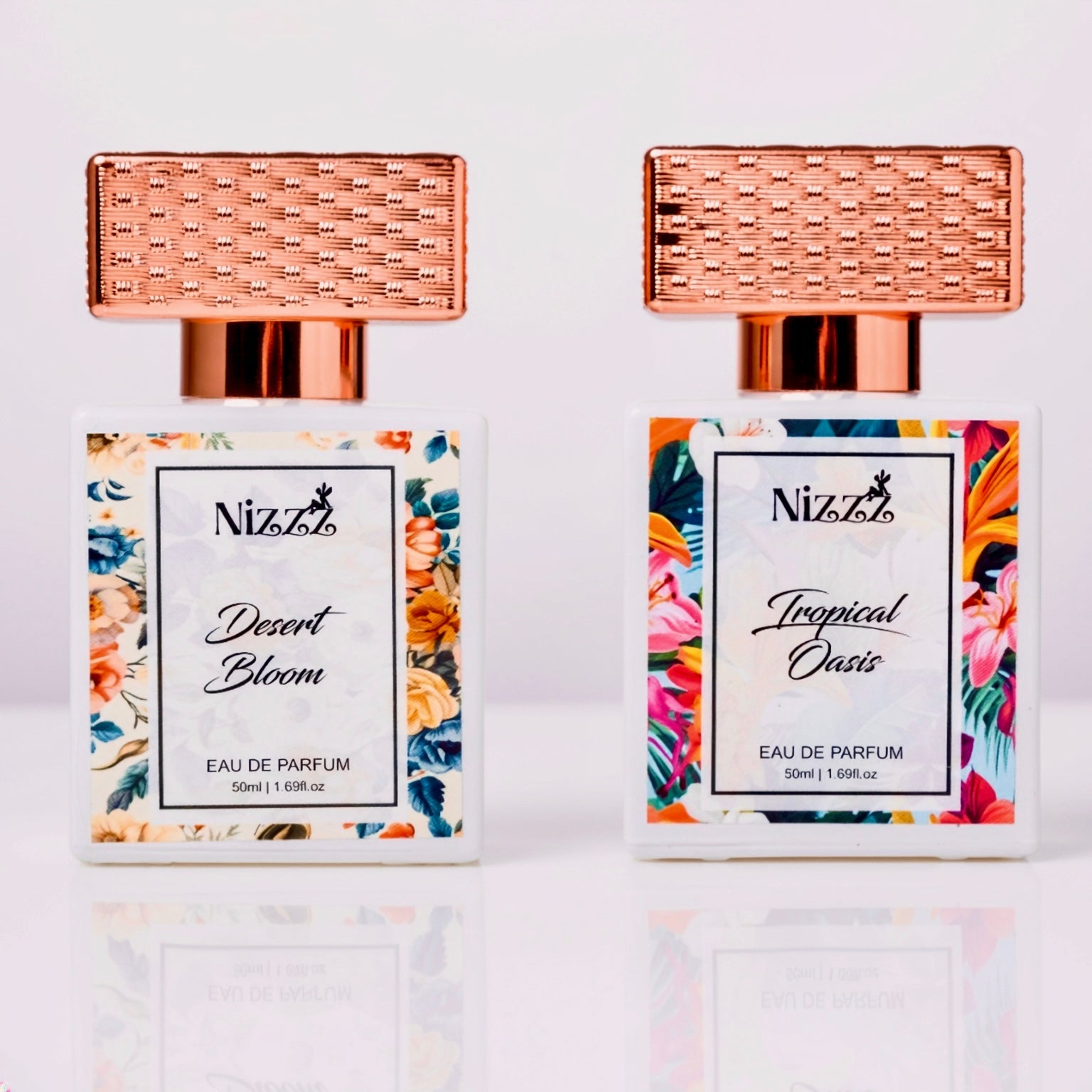 Two Nizzz floral perfume bottles: Desert Bloom & Tropical Oasis, 50ml eau de parfum with rose gold caps