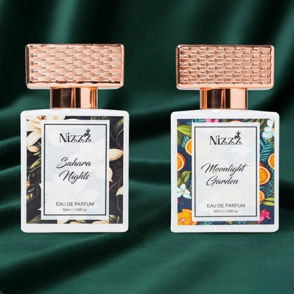Two Nizzz floral perfumes: Sahara Nights & Moonlight Garden, 50ml eau de parfum bottles with rose gold caps on green velvet.