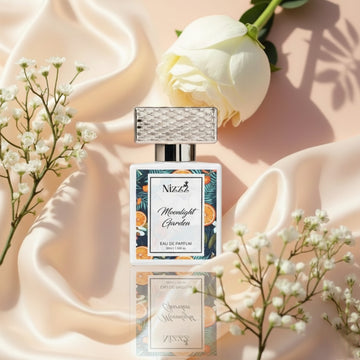 Nizzz Moonlight Garden luxury perfume bottle with flowers on soft satin fabric background